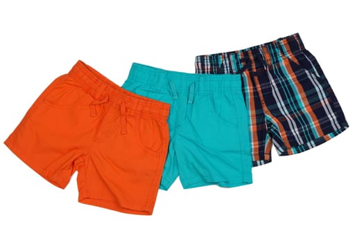 Three colored shorts, orange, blue and plaid. Isolate on white.