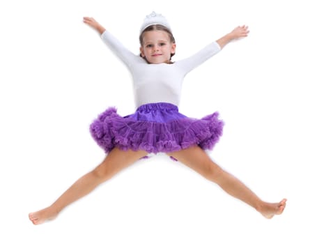 Little girl dancer lying on the floor in the shape of a star. Isolate on white.
