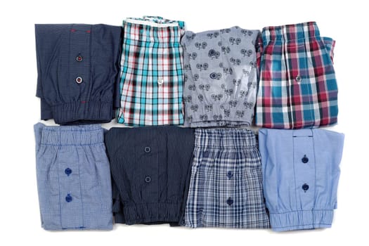 Eight men's briefs folded. Isolate on white.