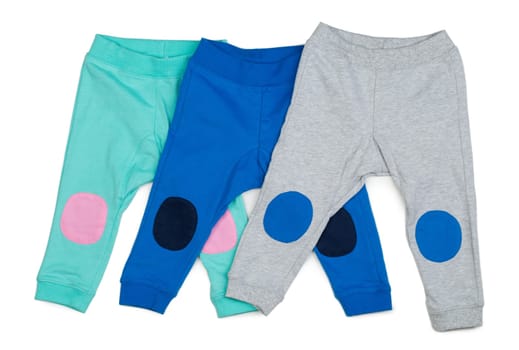 Three colored Cotton baby pants. Isolate on white.