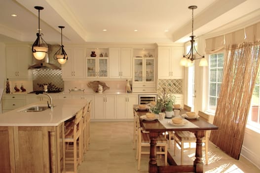 A nice bright kitchen in a new house with a big table and chairs an one.wall only a large window and light fixture..