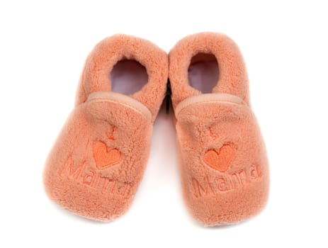 A pair of children's fur bootees with the word "mama."" Isolate on white."