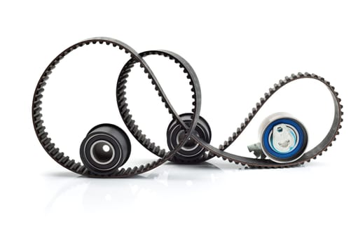 Timing belt, two rollers and the tension mechanism. Isolate on white background.
