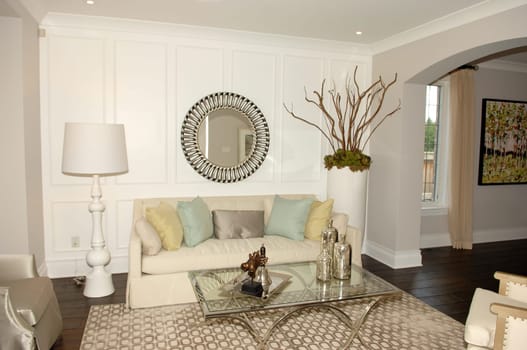 A spaces living room with a sofa and glass table decorated in a new house..