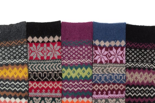 Warm woolen Stockings knitted with national winter pattern on a white background.