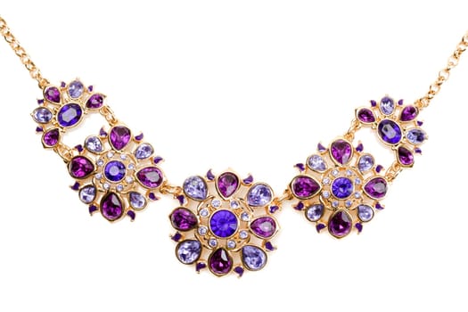 Gold pendant with blue and purple stones. Isolate on white.