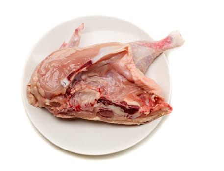 Raw chicken on a plate in a cut. Isolate on white.