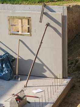 Construction of a prefabricated cellar with a concrete wall with recess for basement windows