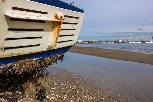 A fishing boat washed up on a beach from a  recent storm in Melbourne.