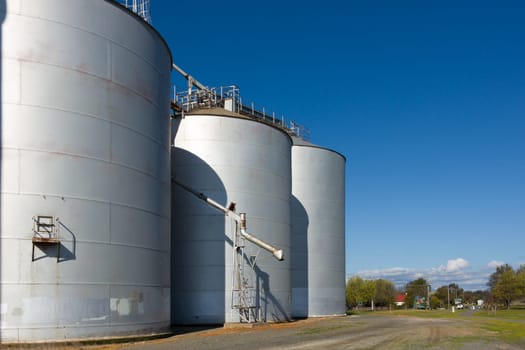Large silos on a clear day, with drop pipe showing.
