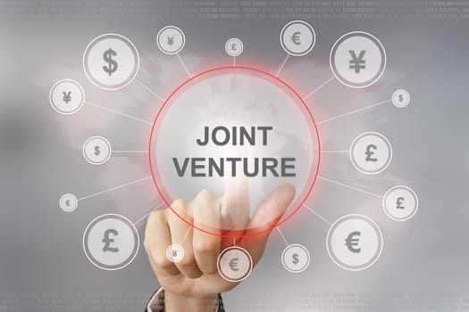 hand pushing joint venture button with global networking concept