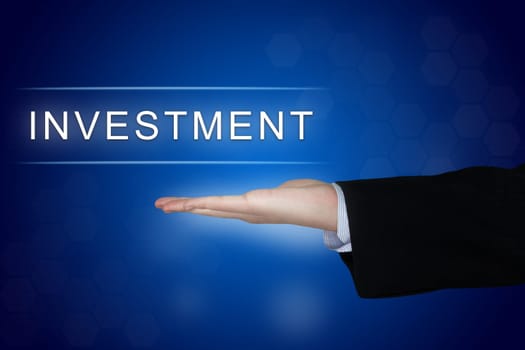 investment button with business hand on blue background