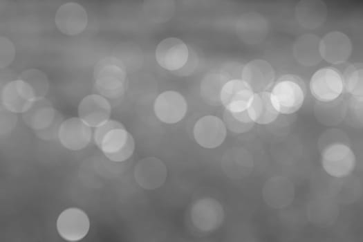Abstract circular natural light black and white bokeh background