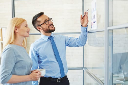 Young businessman showing his plan to CEO