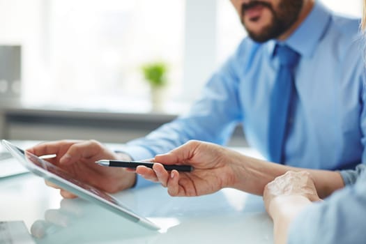 Businesspeople using touchpad in office