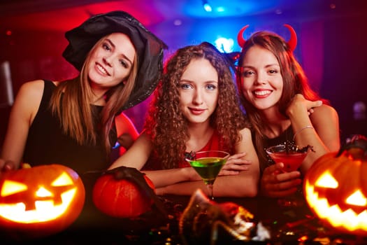 Portrait of three girlfriends at Halloween night