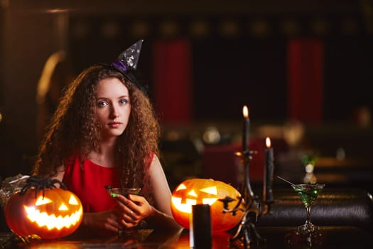 Beautiful witch with martini