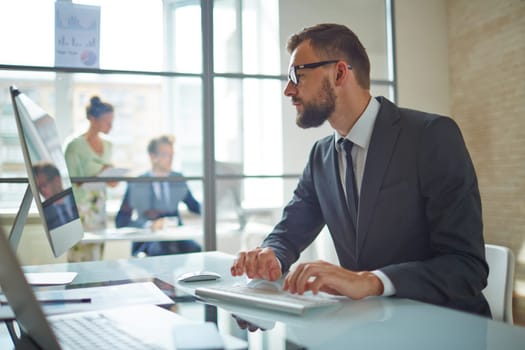 Young employee looking at computer monitor