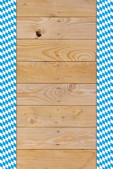 Oktoberfest - original Bavarian flag on old weathered wooden boards. Background with text freedom