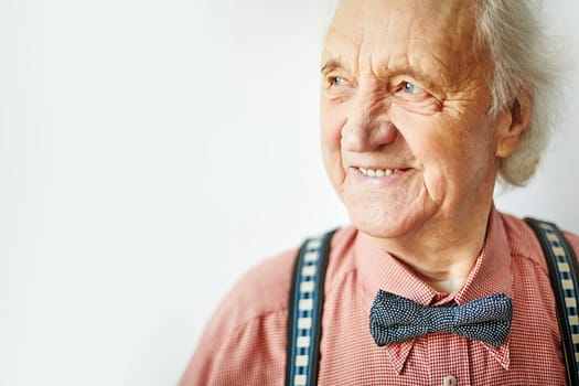 Senior well-dressed man looking aside