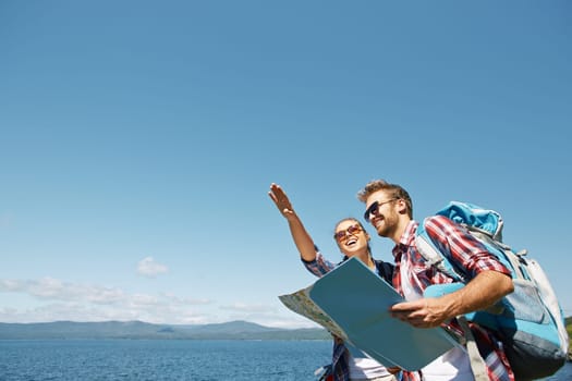 Cheerful hikers with map choosing route for travel