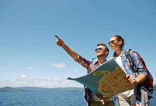 Young couple with map choosing route for further trip