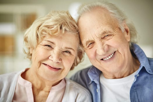 Smiley faces of affectionate senior couple