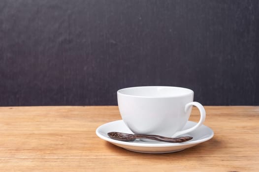 White cup of a coffee on a wooden background