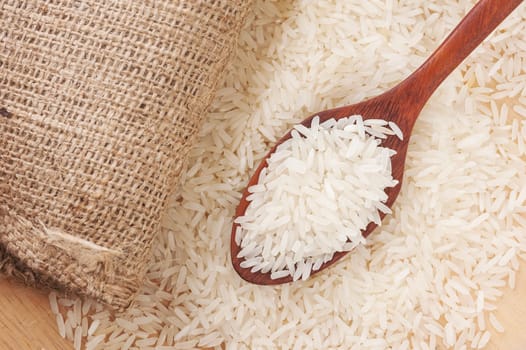 Rice, White rice in wooden spoon with hemp background, Selective focus