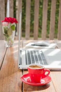 Hot coffee cup on wooden work station, stock photo