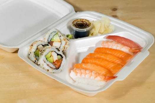 Fast Food Sushi in its box on wooden table.