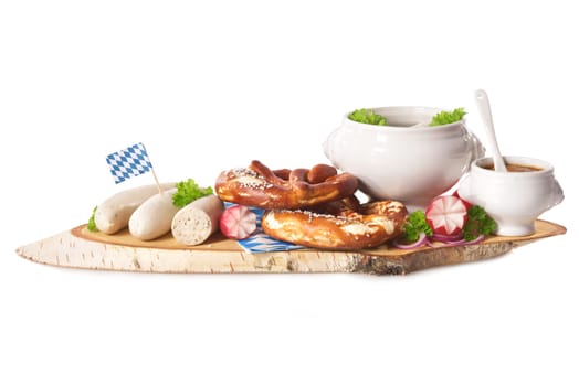 White sausage breakfast with sausages,pretzels and sweet mustard on wooden board