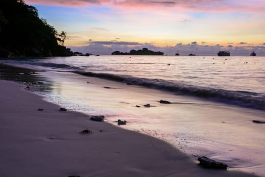 Beautiful colors of morning sky before sunrise on the beach at Honeymoon Bay is a famous attractions for diving on Ko Miang island in Mu Koh Similan National Park, Phang Nga Province, Thailand.