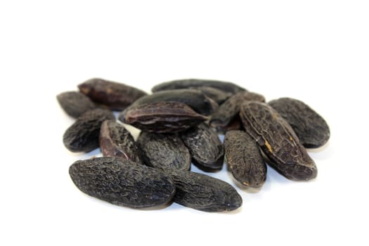 dried tonka beans against a white background