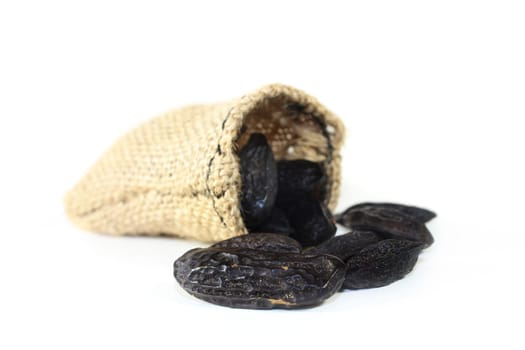 dried tonka beans against a white background