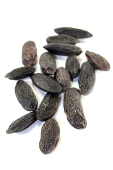 dried tonka beans against a white background