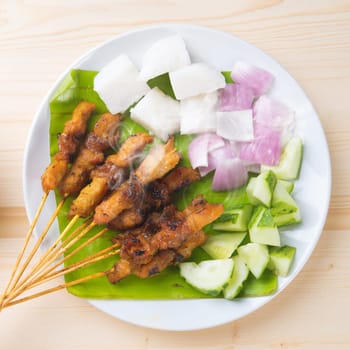 Skewered and grilled meat , chicken sate or satay, served with peanut sauce. Fresh cooked with steamed and smoke. Delicious hot and spicy Asian dish.