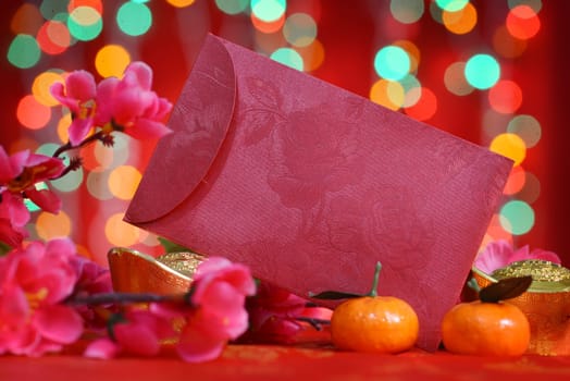 Chinese new year festival decorations, ang pow or red packet with copy space ready for text, on glitter red background.