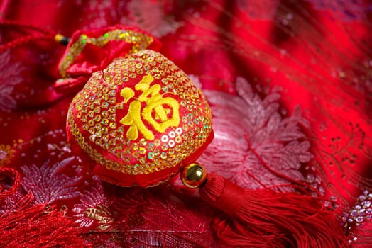 Chinese new year decorations, lucky bag on red background. The Chinese character means "lucky"", not a logo or copyright."