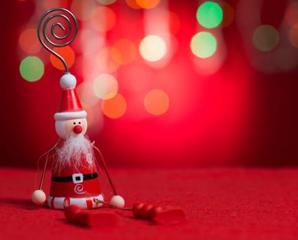 Christmas decorations santa claus with blurry glitter shiny lights at background.