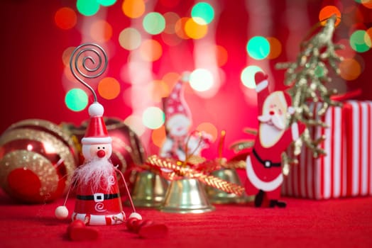 Christmas decorations with blurry glitter shiny lights at background. Bells and presents.