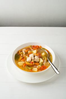 Fresh chicken and vegetable stew on white table