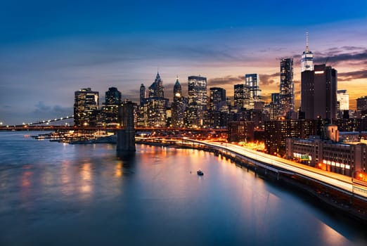 New York City - beautiful sunrise over manhattan with manhattan and brooklyn bridge USA