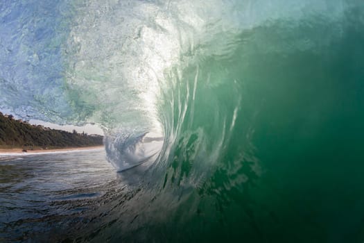 Ocean wave swimming inside crashing water power tube detail.