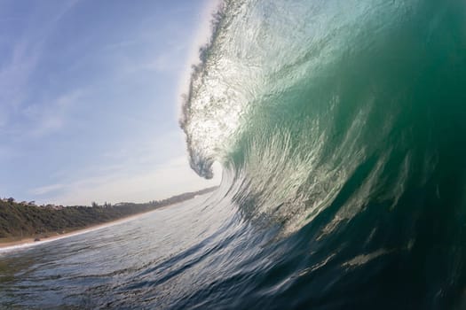 Ocean wave swimming inside crashing water power tube detail.