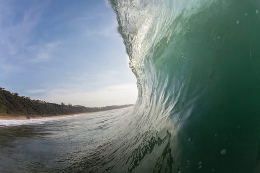 Ocean wave swimming inside crashing water power tube detail.