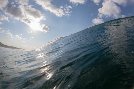 Ocean wave swimming inside crashing water power tube detail.