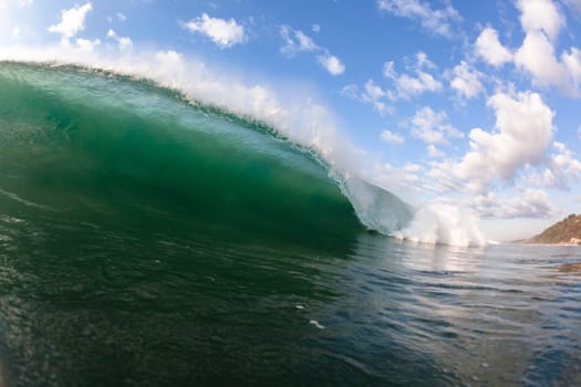 Ocean wave swimming inside crashing water power tube detail.