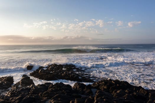 Ocean waves water crashing hollow energy power along rocky coastline.
