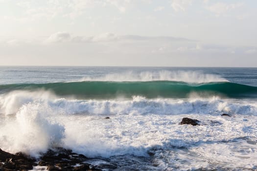Ocean waves water crashing hollow energy power along rocky coastline.